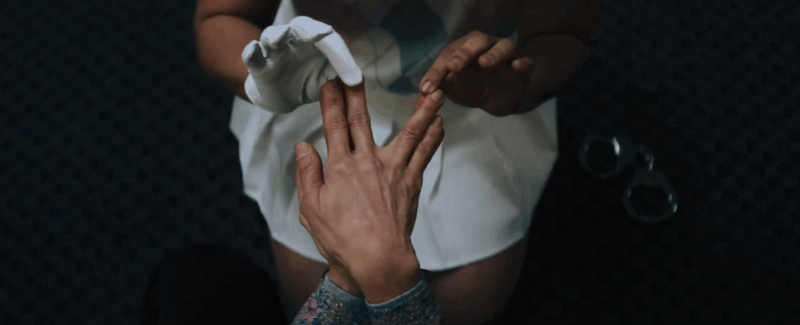 a picture of a person holding another person's fingers and parting them
