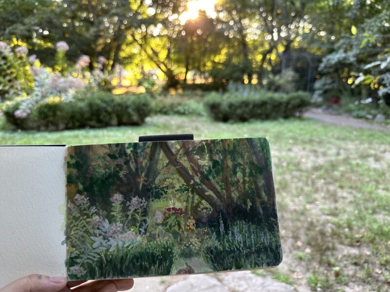 painting of a woody garden in front of same scene IRL
