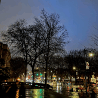 massachusetts avenue traffic at twilight, with puddles and clouds from a recent storm