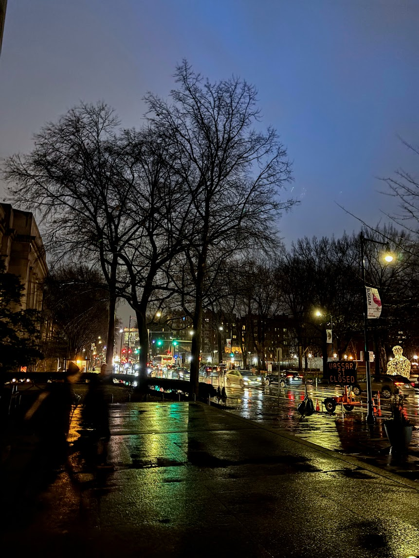 massachusetts avenue traffic at twilight, with puddles and clouds from a recent storm