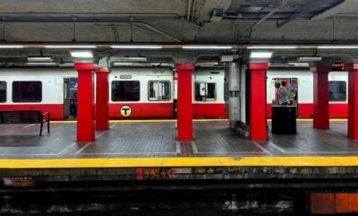 red line metro station with opposite train about to depart