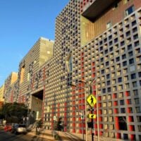 facade of simmons at sunrise, with grid of thousands of windows adorning the front wall