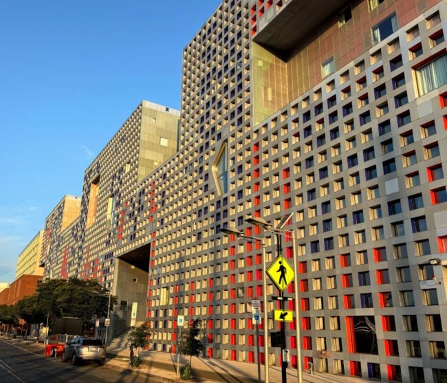 facade of simmons at sunrise, with grid of thousands of windows adorning the front wall