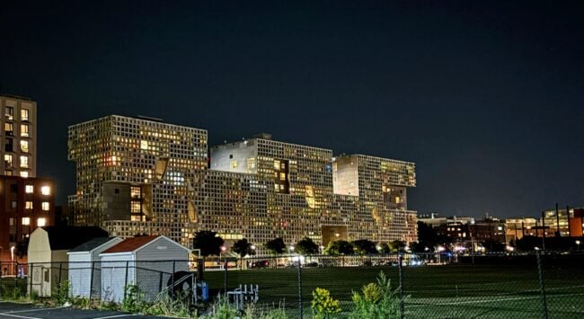 panoramic view of simmons from across briggs field at night, showing honeycomb-like structure