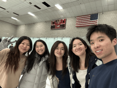 5 people smiling on ice rink