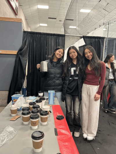 three people posing with hot cocoa