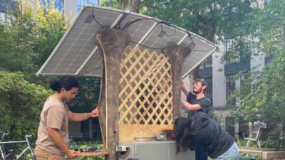 Two students building a structure.