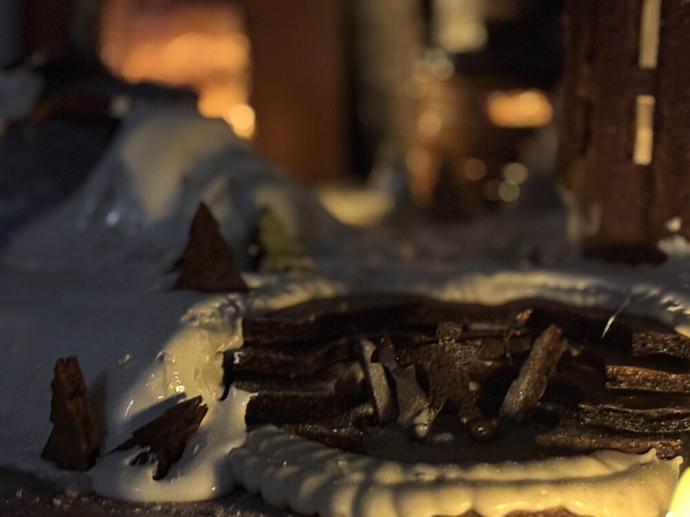 a dimly lit photo of gingerbread and icing lit by yellow light