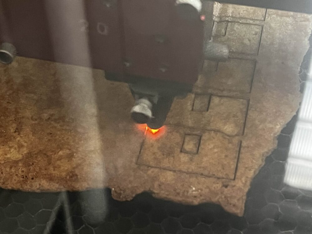 picture of a laser cutter cutting shapes out of gingerbread