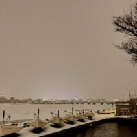 frozen charles river covered in a thick layer of snow, with docks and boats in&hellip;