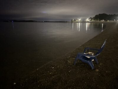 An adirondack chair by the shore.