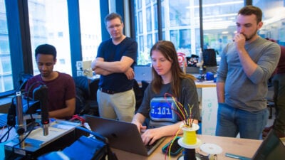 Students looking at a computer screen together.