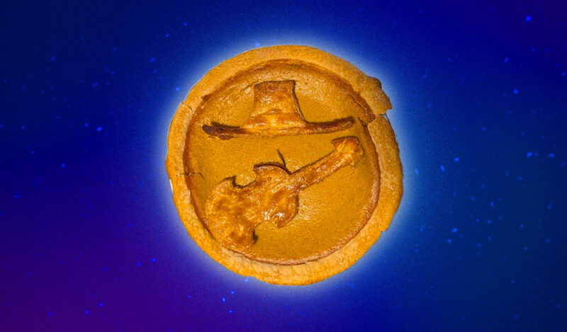 A pumpkin pie with crust cutouts of a sombrero and a violin