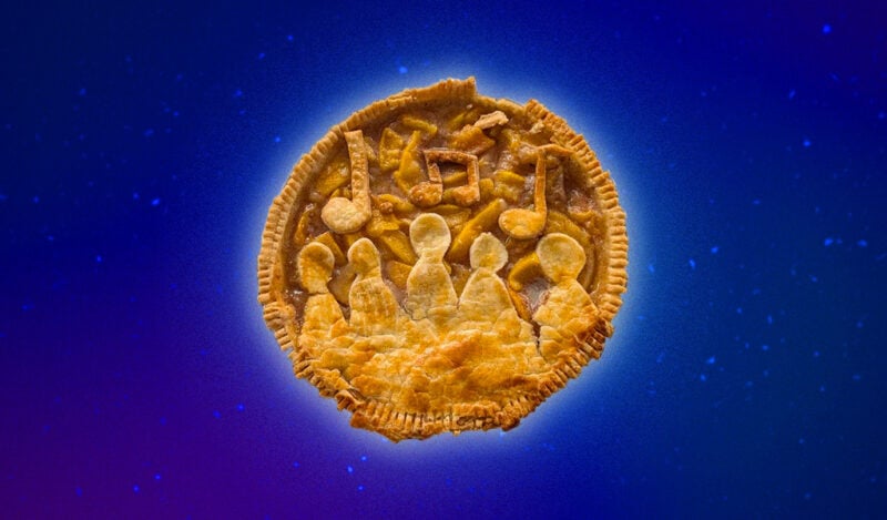 A peach pie with pie crust on top depicting five singing people and music notes