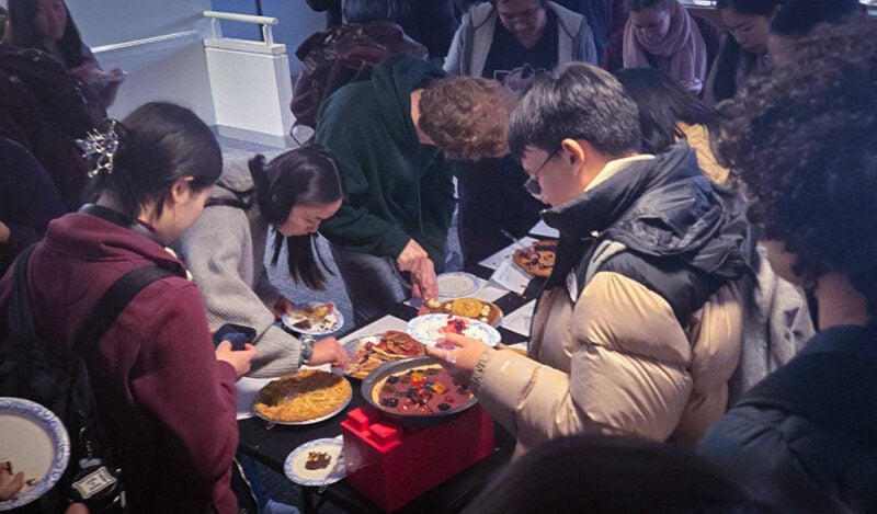 A group of MIT students digging into a variety of pies.