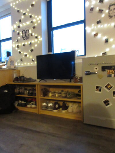 a tv above a shoe rack