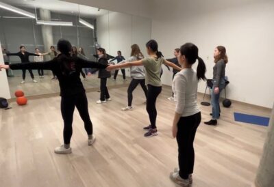 people positioning themselves to do practice in a dance room 