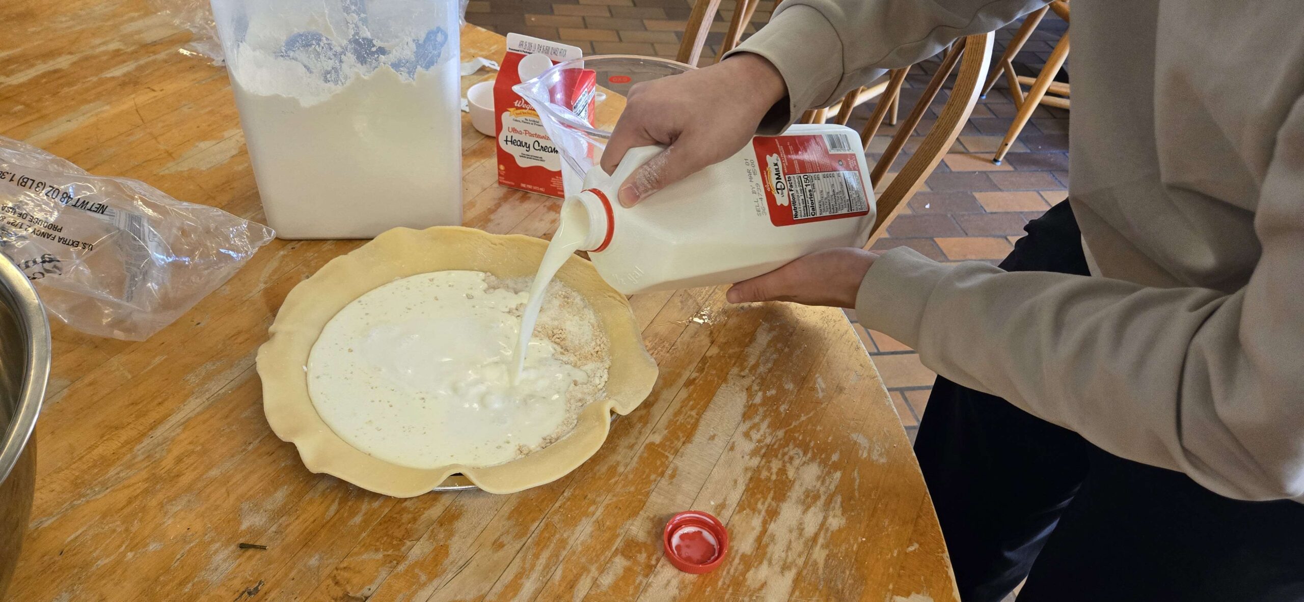 milk being poured into pie