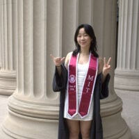 a girl poses in front of a pillar holding up a 6 and a 2,&hellip;