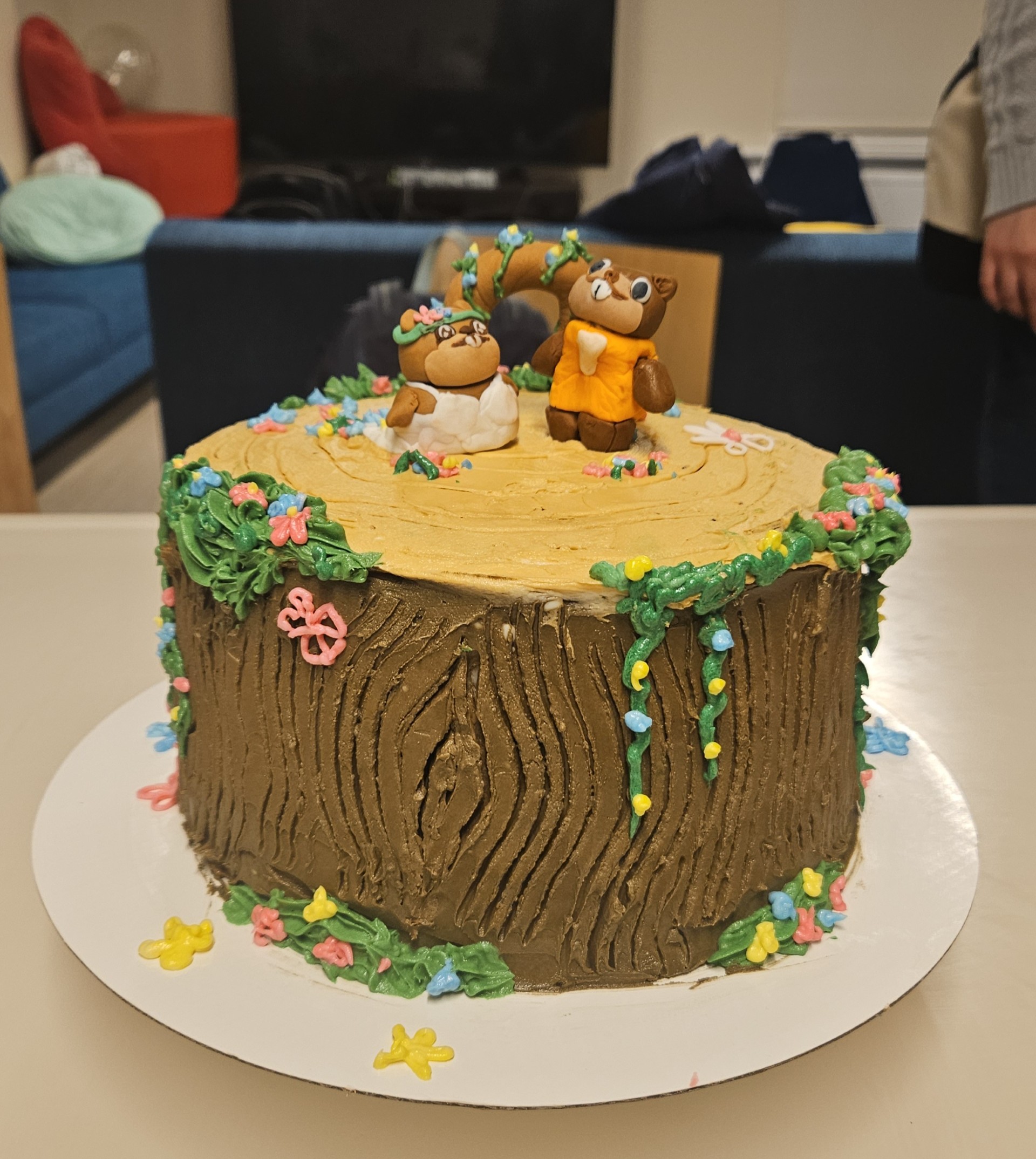 two beavers on a log cake