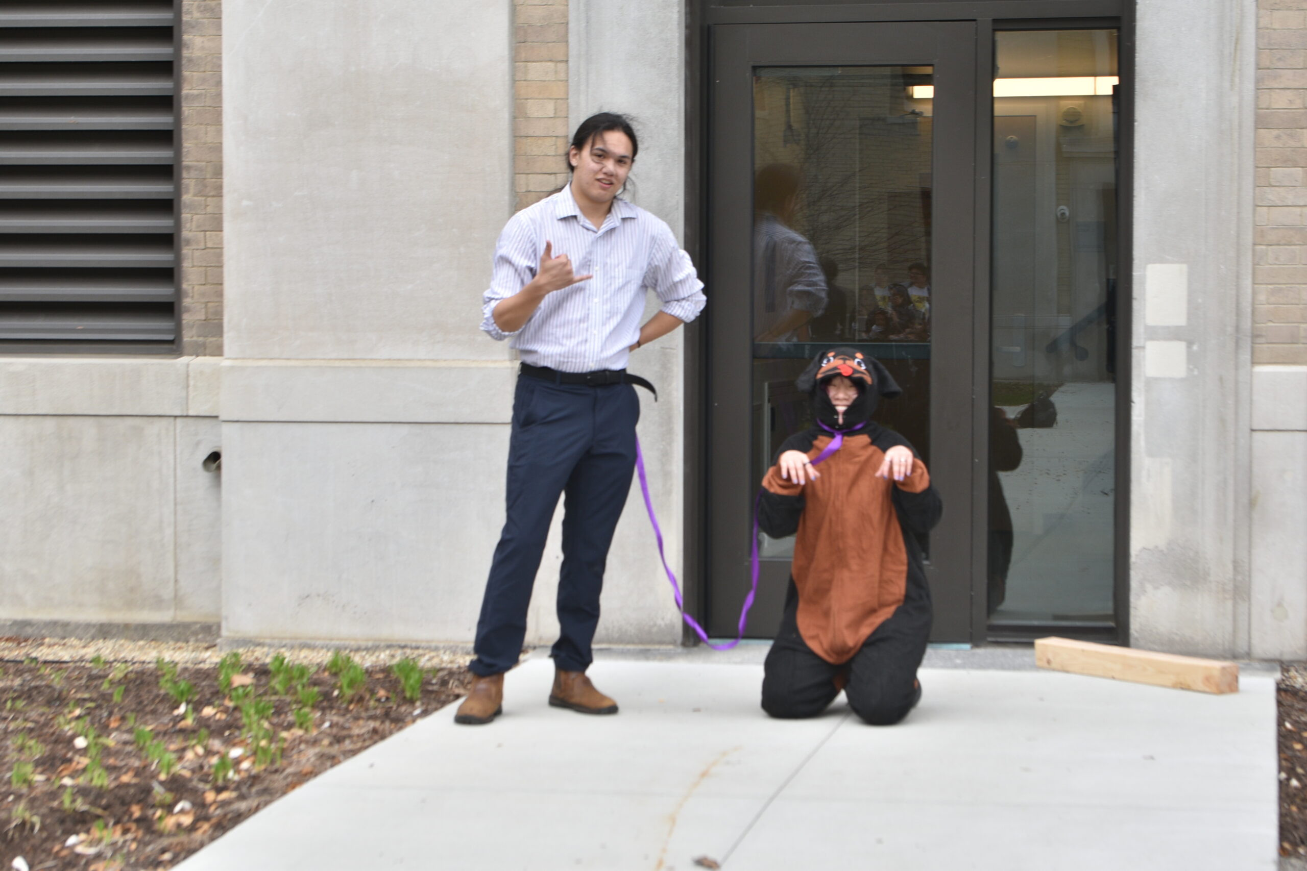 kath in a dog costume stanced up next to a door, ready to be the ring bearer