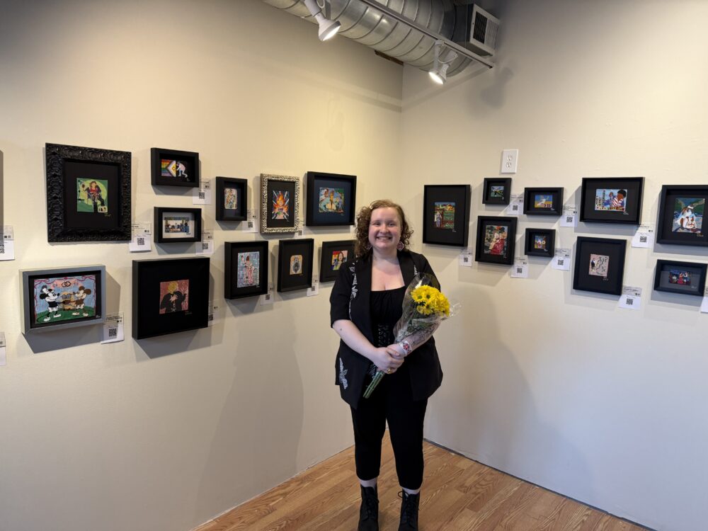 yuliya in front of art at solo exhibit