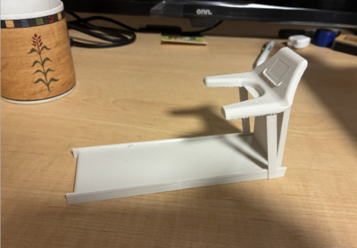 a small white 3d printed plastic treadmill, about 6 inches long