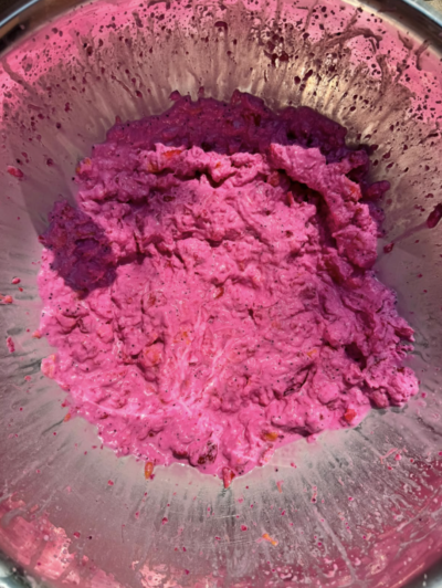 Vibrant pink slush at the bottom of a metal bowl.