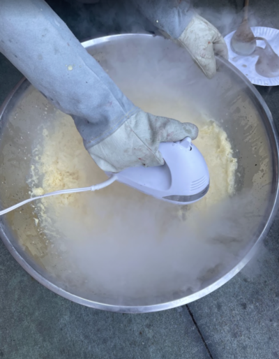 Orange ice cream in a metal bowl