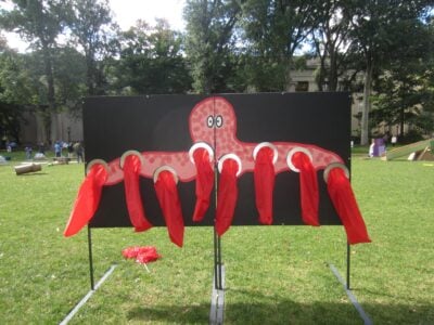 a cardboard octopus with 8 gloved tentacles.