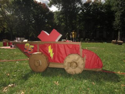 a cardboard lightnng mcqueen with a puzzle piece inside