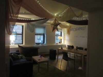 a living room suite, with draping on the ceiling and fairy lights
