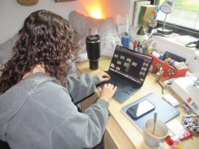 an overhead view of my roommate, working on her laptop
