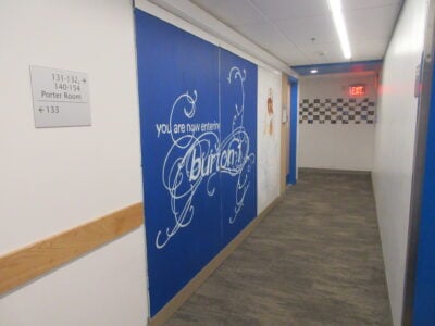 a hallway with a mural that says 