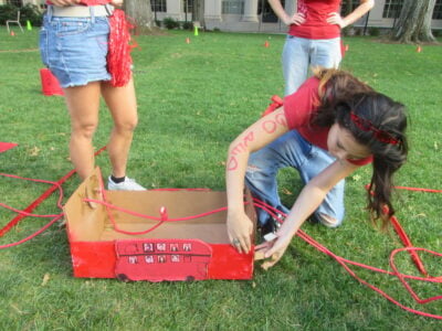 a teammate fixing the cardboard bus