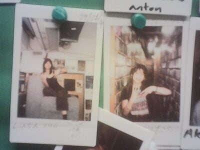 two polaroids pinned up on photo wall in WMBR