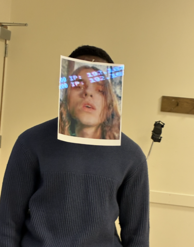 tyler has a printed paper image of brakence on his face