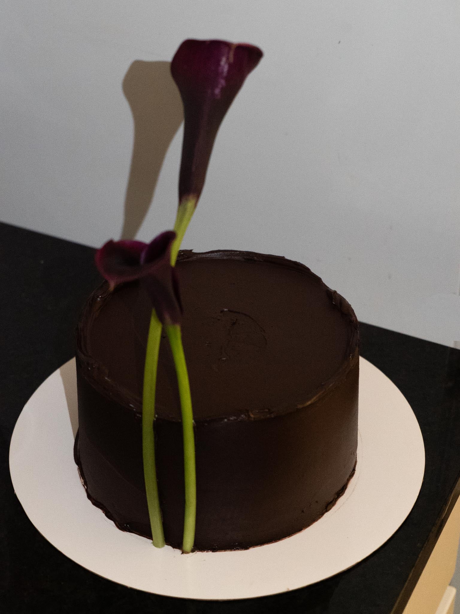 dark chocolate cherry cake with calla lilies