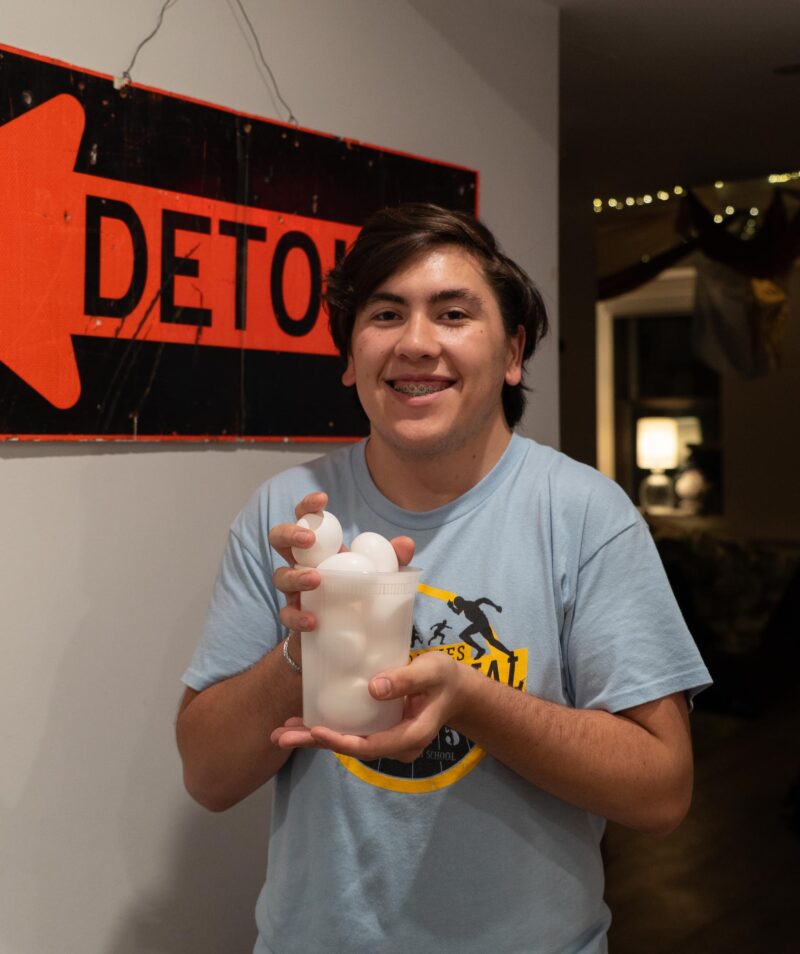 John holding deli container filled with eggs