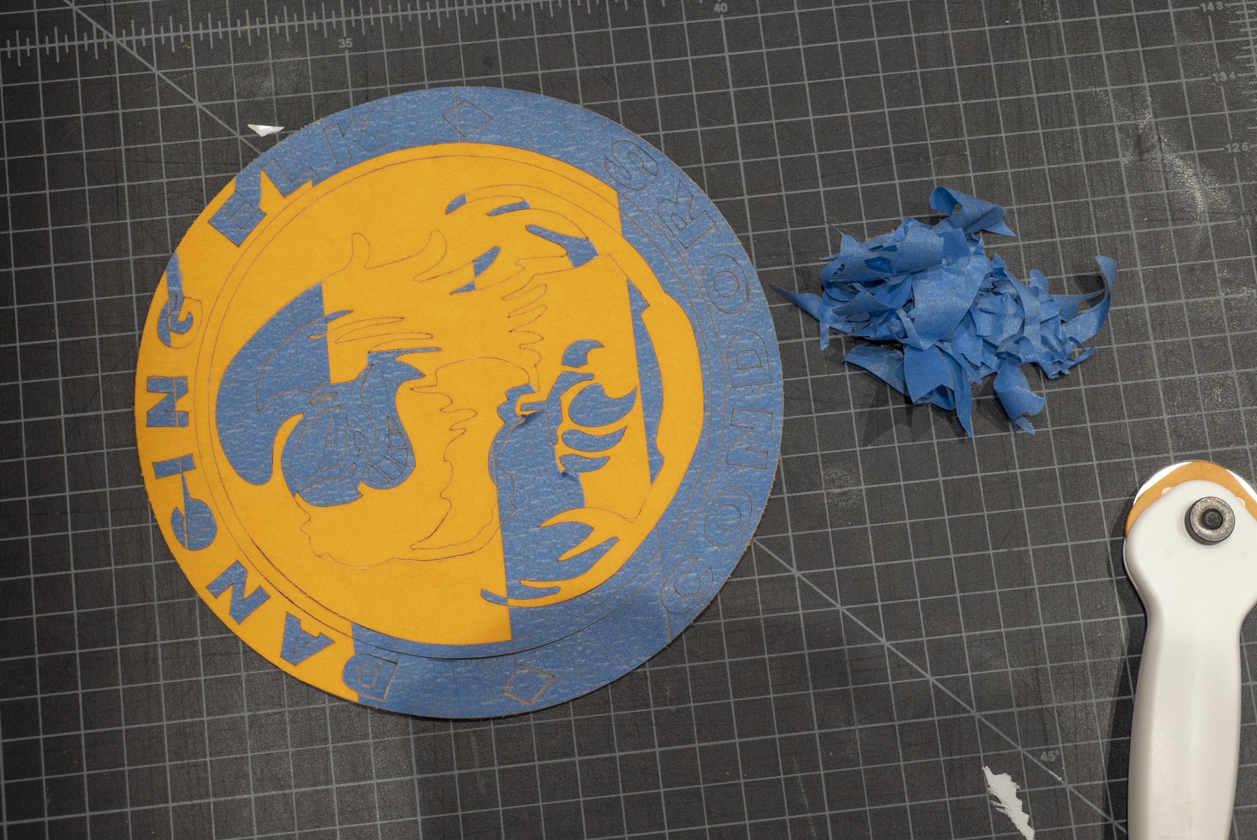 peeling off blue tape from yellow graphic